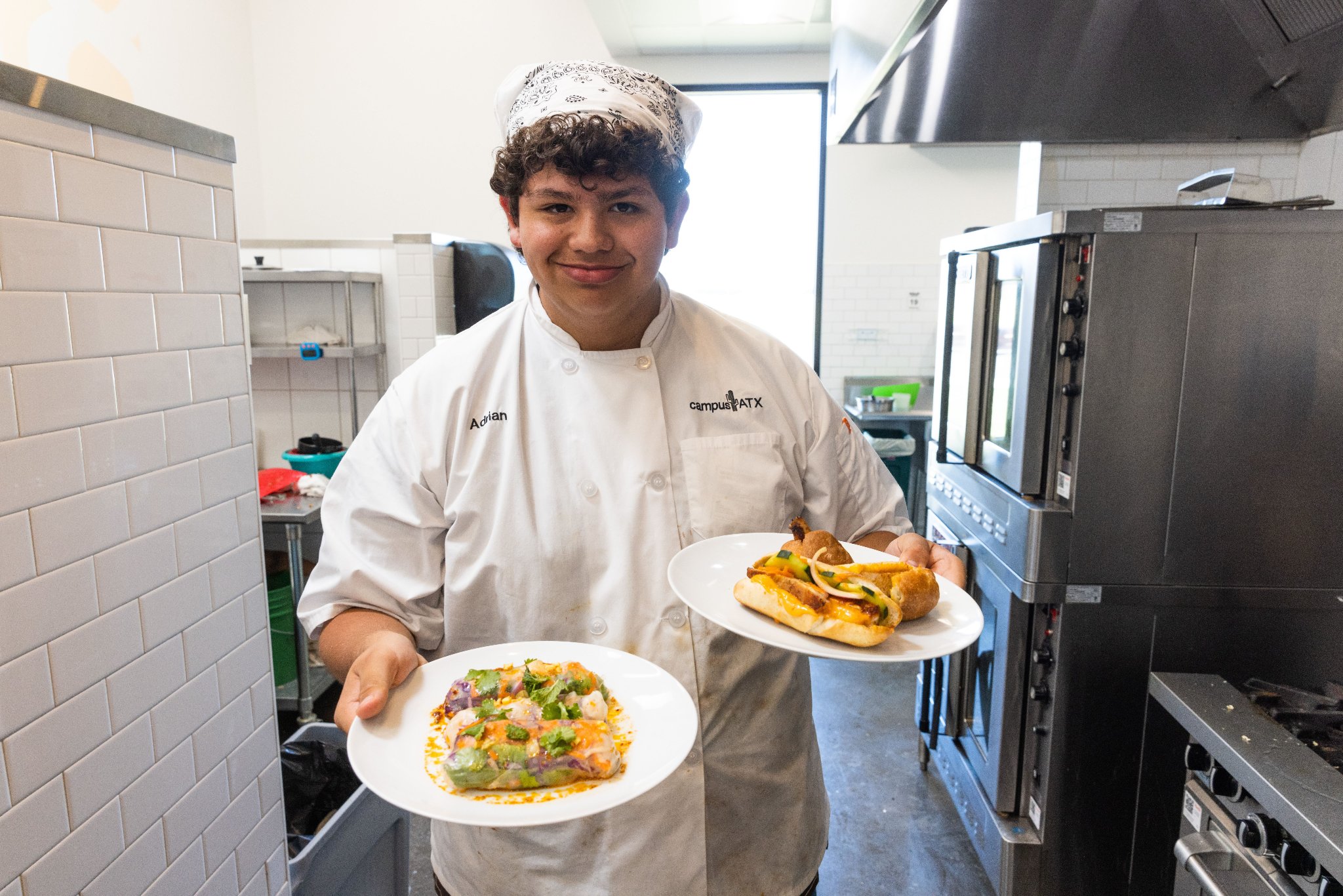 Teen camper proudly holding two plated competition dishes
